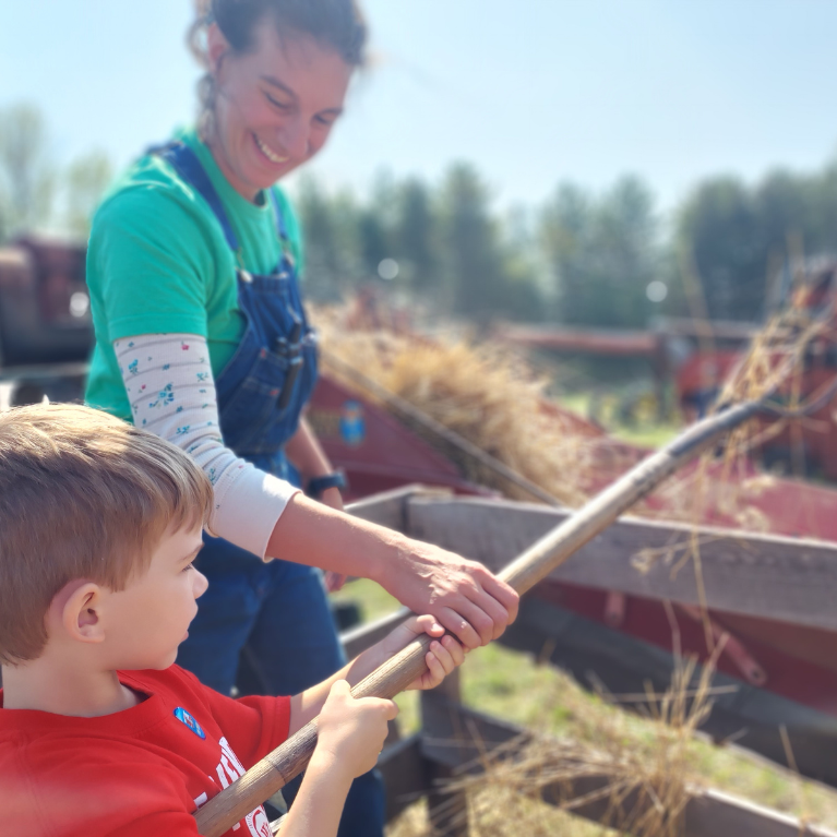 MID LAKES AGRICULTURAL FAIR THROWING HAY